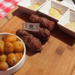 mititei served for lunch with fried baby potatoes and a selection or Romanian mustards