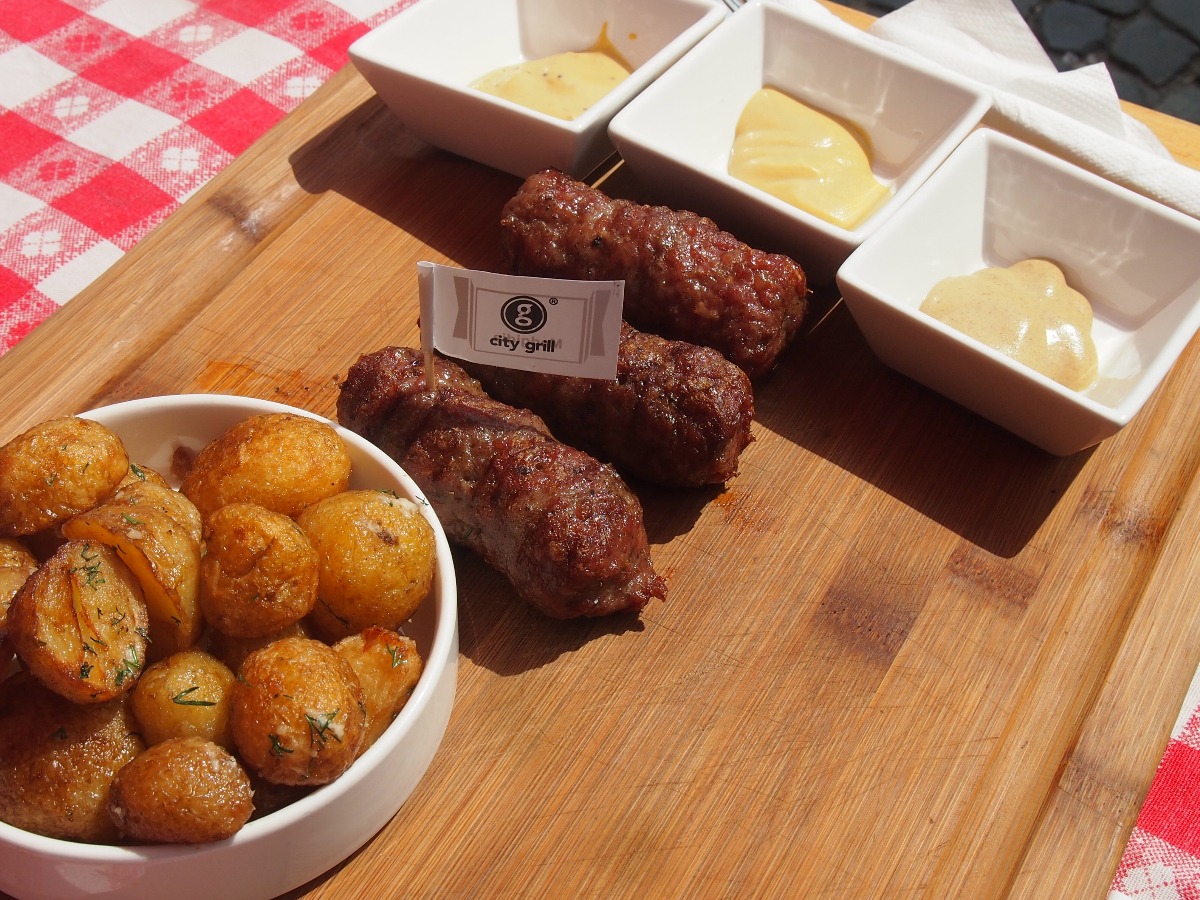 mititei served for lunch with fried baby potatoes and a selection or Romanian mustards